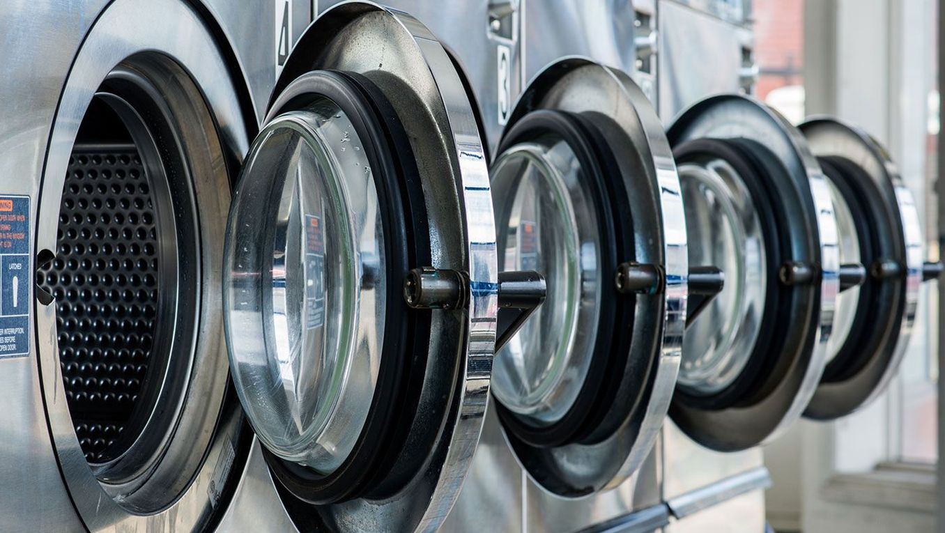 a row of washing machines in a launderette 
